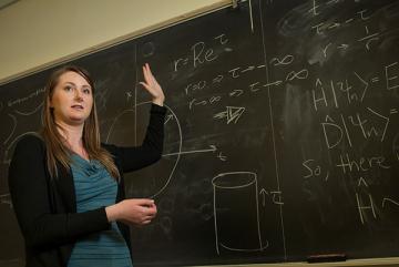 Rachel Houtz explains a physics concept to a class.