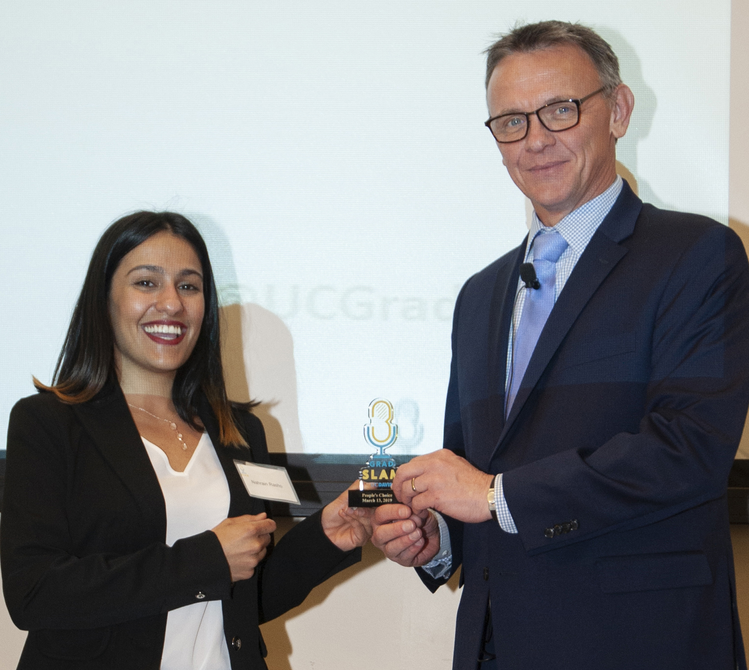 Photo of UC Davis political science student receiving small trophy