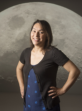 Photo of UC Davis professor Sarah Stewart in front of image of the moon