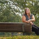 Katy Pattison sits on a bench.