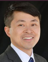 Portrait photo of UC Davis comparative literature Ph.D. alumnus Christopher Tong, smiling. 