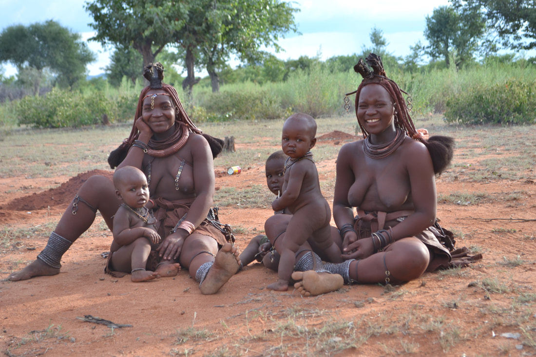 Adults and children from Namibia's Himba commmunity gather together for a photograph.. 
