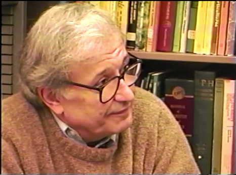 Close-up of UC Davis political scientist Ed Costantini, wearing glasses, bookshelf behind him. 