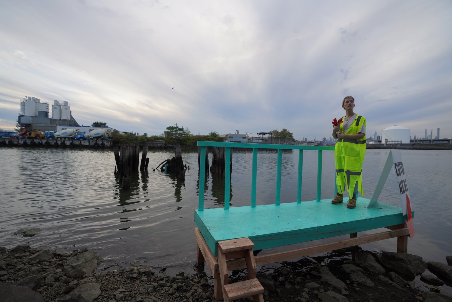 Charlotte Mundy is standing on a platform out in a large body of water