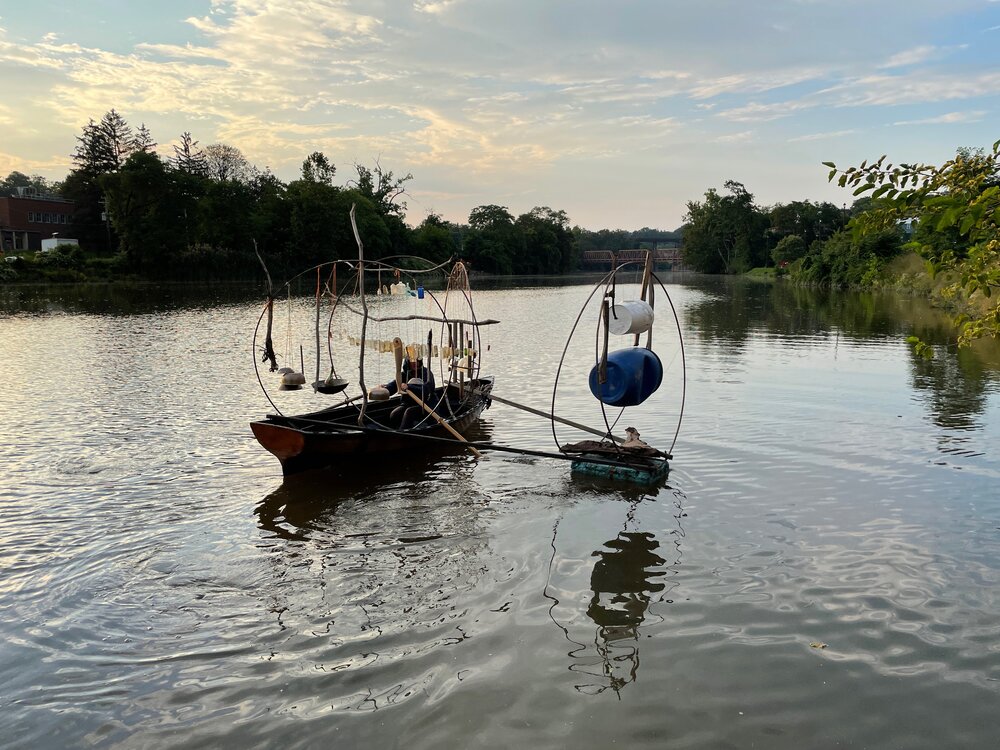 A boat with a wave chime on it is out in a large body of water