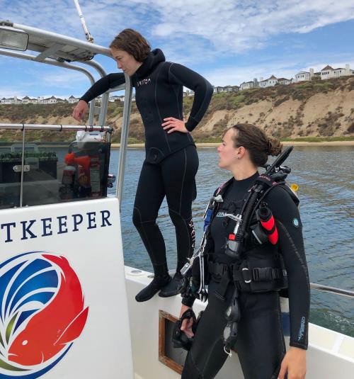 Aurora Ricart, left, and Melissa Ward stand aboard a research vessel while conducting UC Davis field work aimed at understanding seagrass’ capacity to buffer ocean acidification.