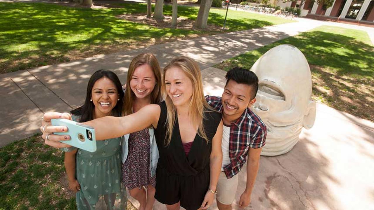 These students from the College of Letters and Science include, from left, Cindy Suzuki, a design major; Hailey Jenkins, a communication major; Lindsey O’Tousa, a psychology major; and Miguel Bagsit, a communication major. They posed at a popular selfie site with the “Eye on Mrak (Fatal Laff)” Egghead. (Gregory Urquiaga/UC Davis)