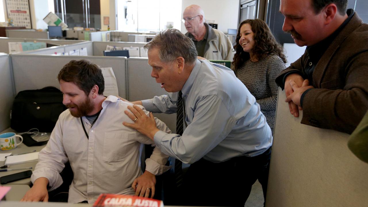 Photo: surprised staffers in news room