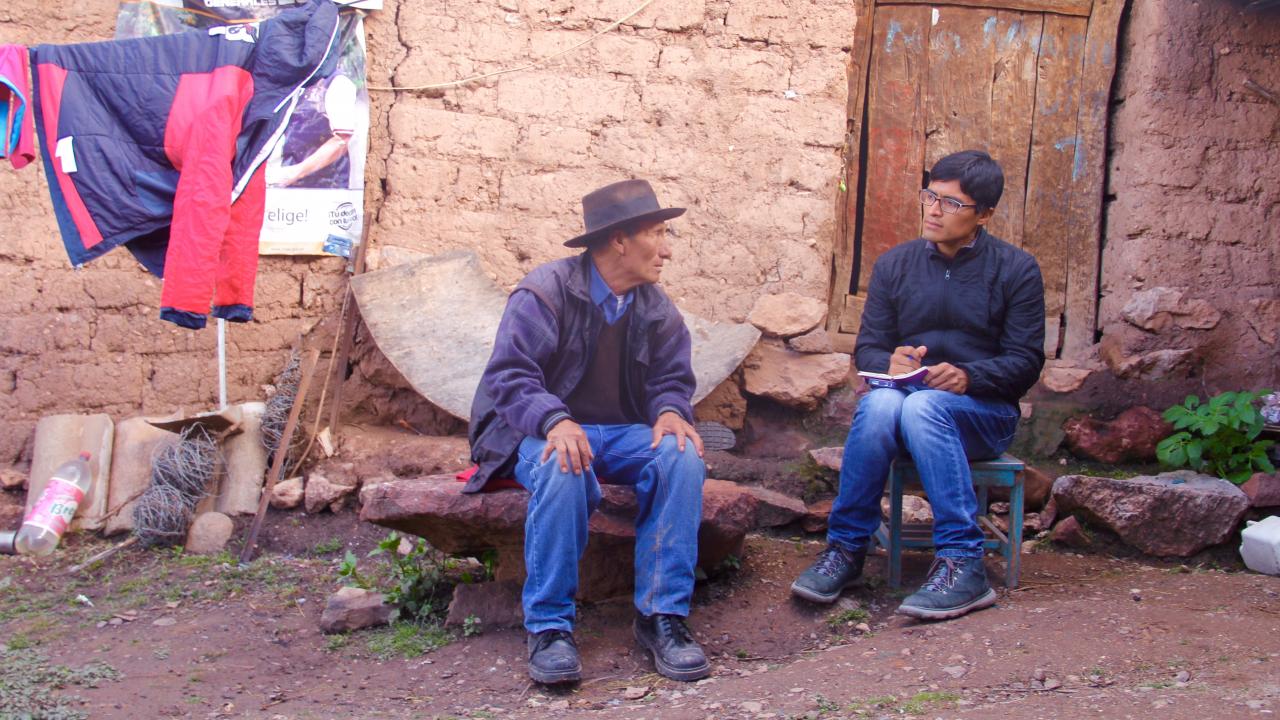 Photo of UC Davis history graduate student Renzo Aroni interviewing a Peruvian peasant.