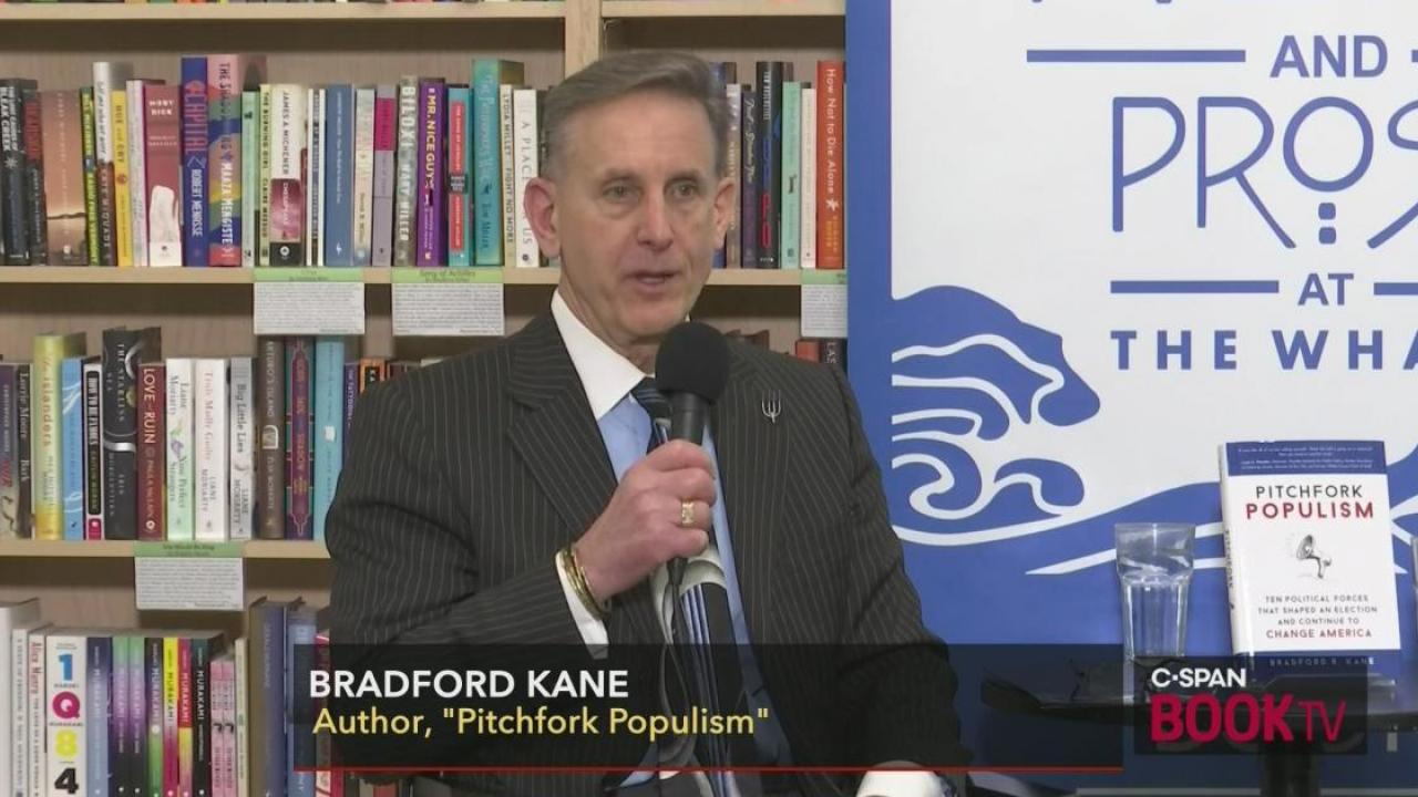 Photo of Bradford Kane on C-SPAN Book TV program, addressing audience at a bookstore book talk. 