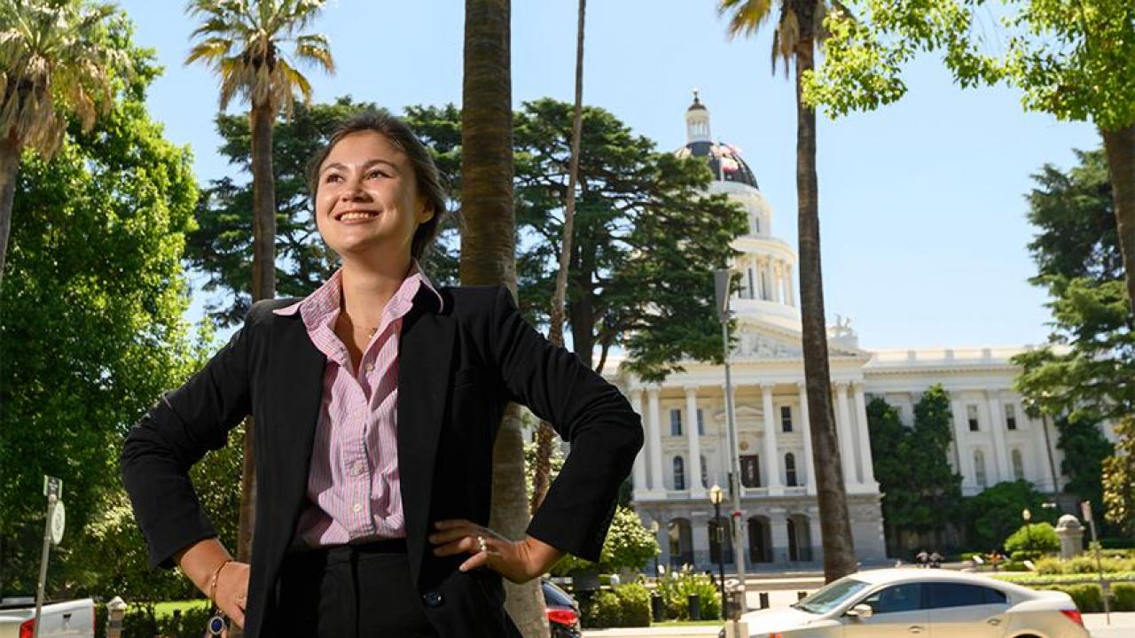 Portrait of UC Davis history/political science student in front of the California state Capitol in Sacramento. 