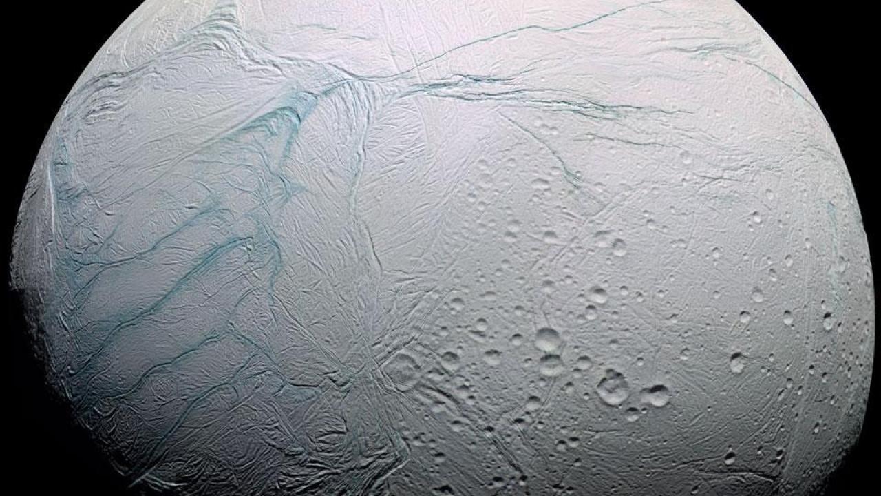 Saturn’s tiny, frozen moon Enceladus is slashed by four straight, parallel fissures or “tiger stripes” from which water erupts. These features are unlike anything else in the solar system. Scientists at UC Davis, the Carnegie Institution and UC Berkeley now have an explanation for them. (NASA/JPL/Space Science Institute image). Enceladus