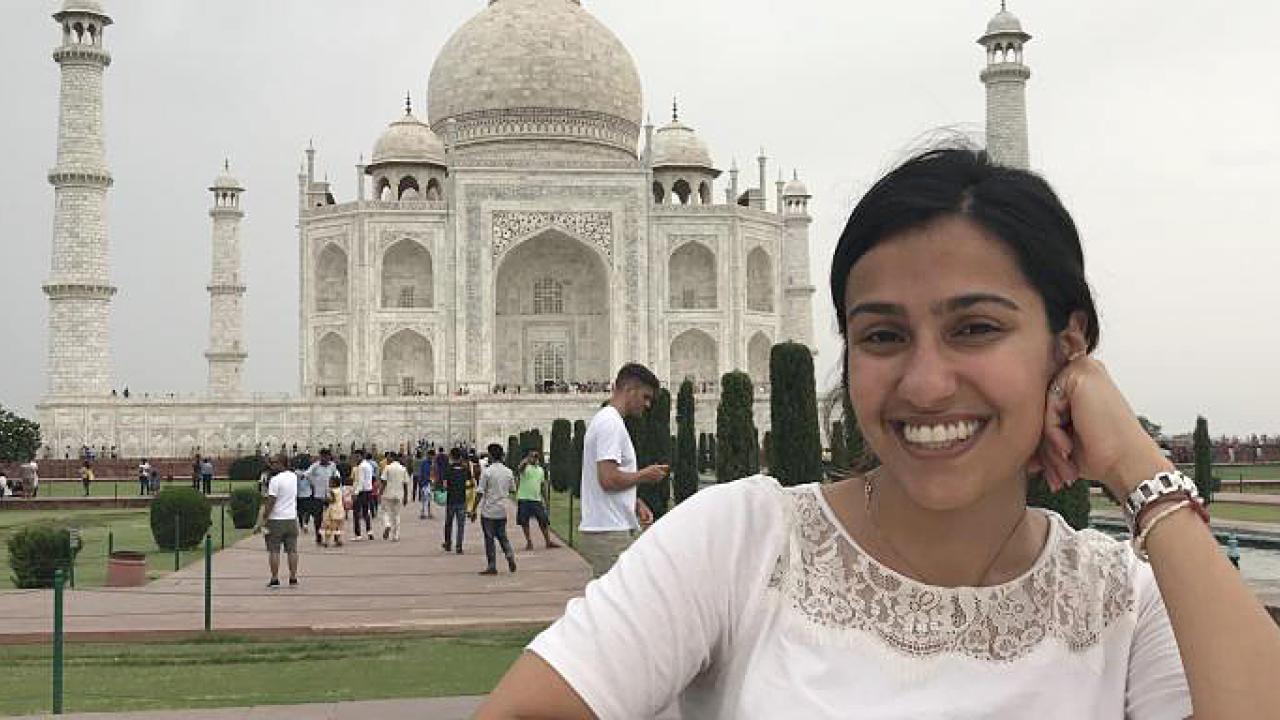 Photo of UC Davis political science graduate student in front of India's Taj Majal 