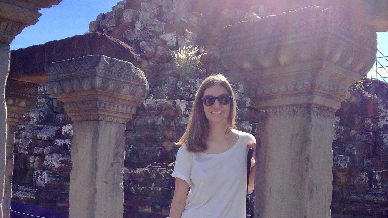 Olivia Coffman, a 2018 graduate of the UC Davis College of Letters and Science, traveling in Cambodia before her Sri Lankan Fulbright experience. She is one of seven college alumni offered Fulbright awards for 2018-19. Photo: young woman standing by columns of an ancient site