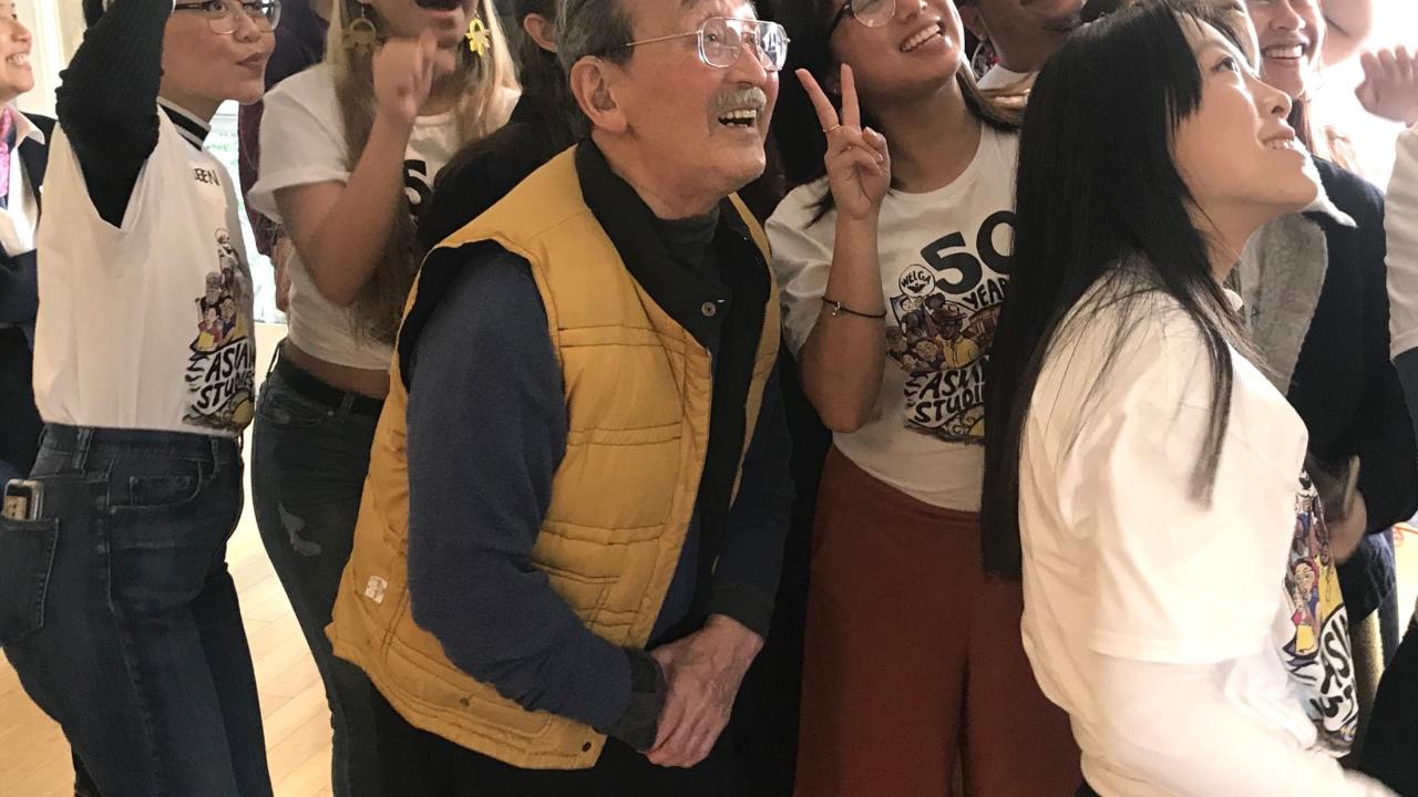 Isao Fujimoto takes a selfie with students at a recent event honoring him. 