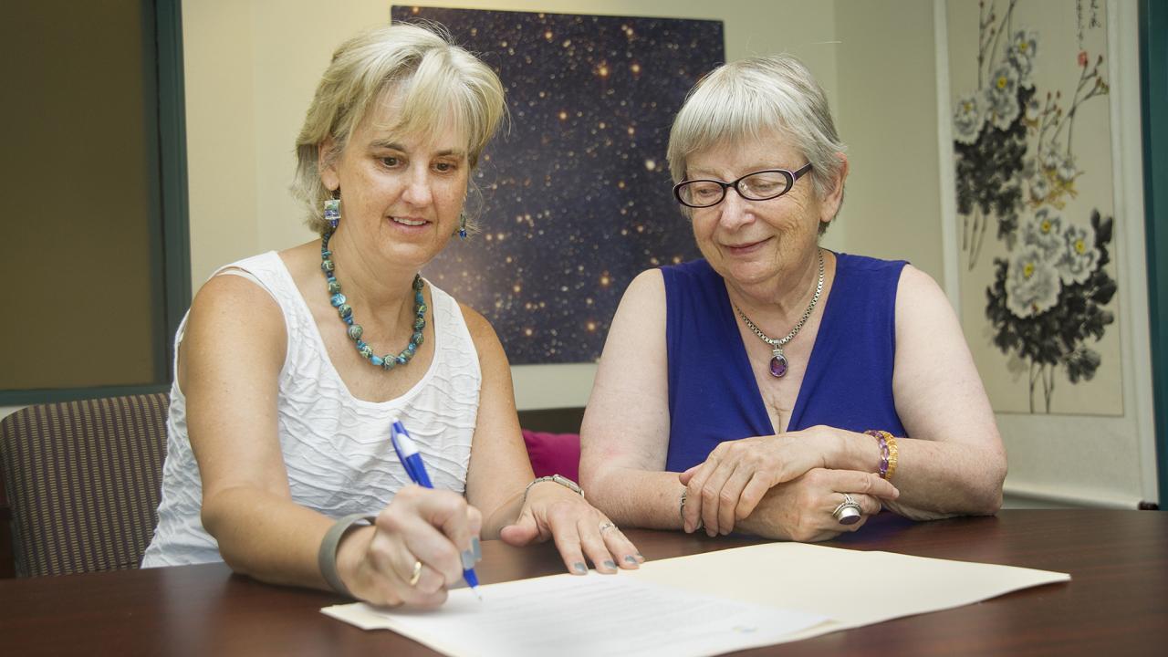 Interim Dean Alex Navrotsky and Department Chair Susan Kauzlarich sign the Green Chemistry Commitment.