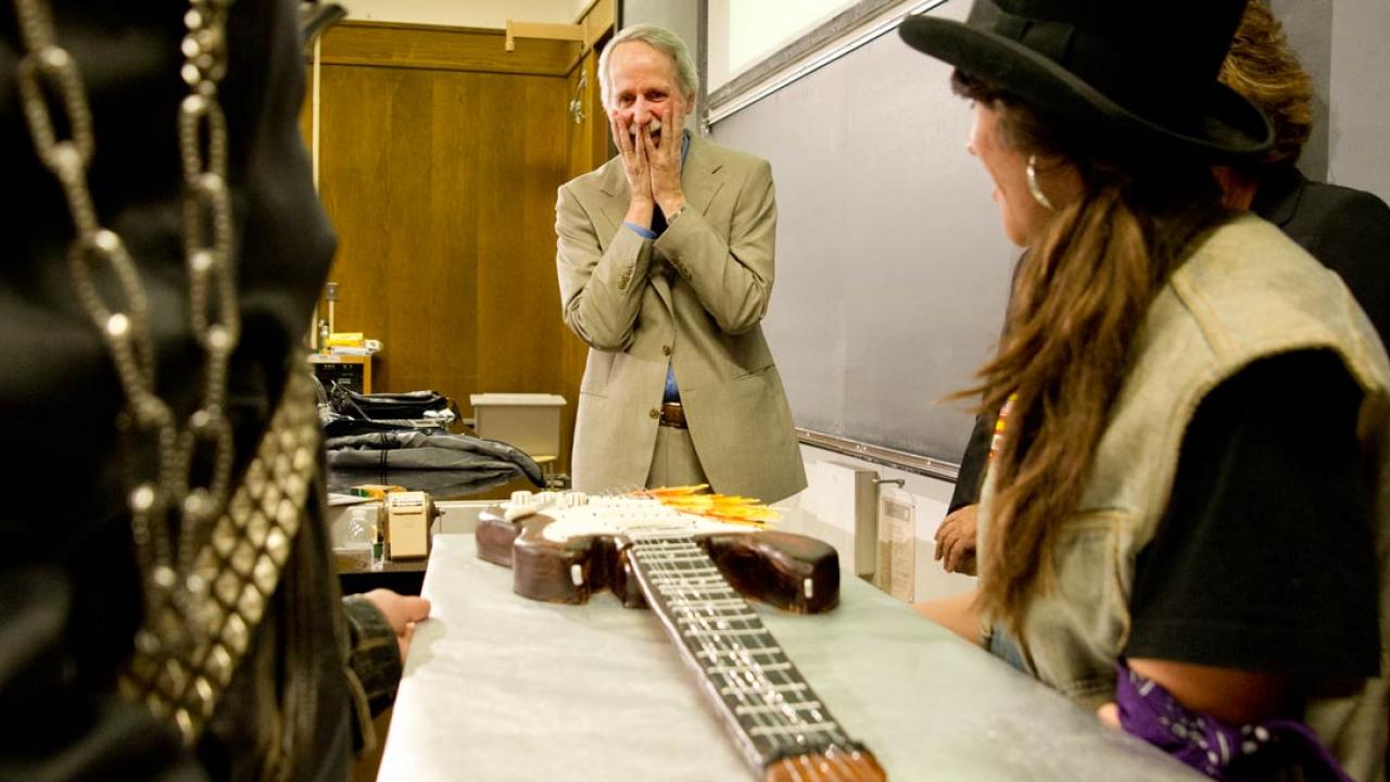 Christopher Reynolds with the guitar-shaped cake he was presented with upon winning the UC Davis Undergraduate Teaching and Research Prize in 2013. Christopher Reynolds, music professor, retiring honors