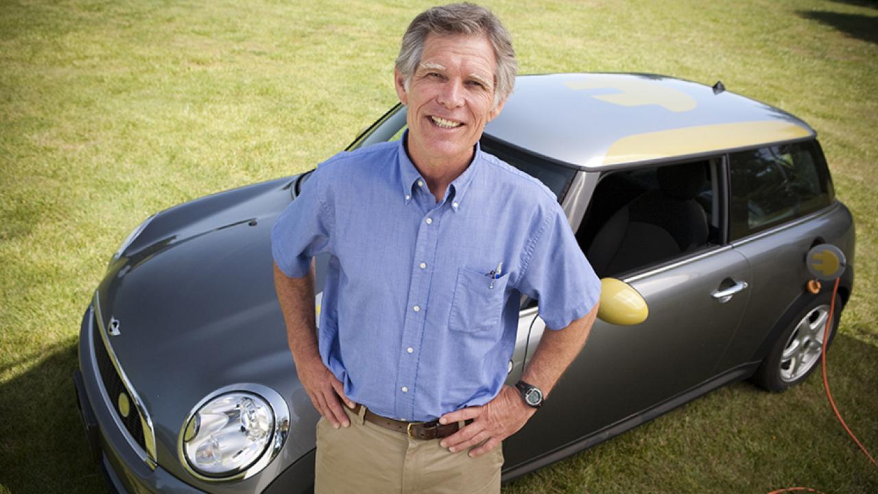 Photo of UC Davis anthropology alumnus Tom Turrentine standing in front of a car. 