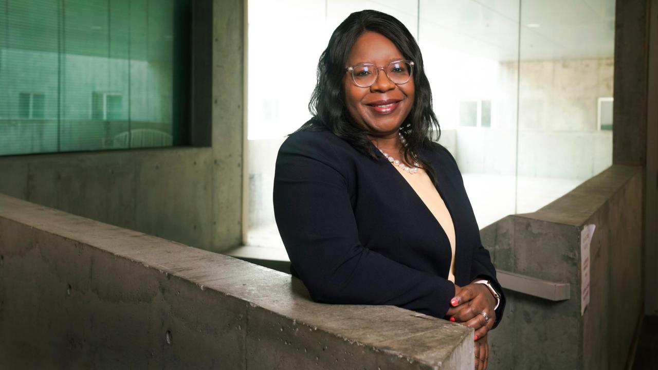 A portrait of UC Davis Dean Estella Atekwana standing in a staircase at the SS&H building.
