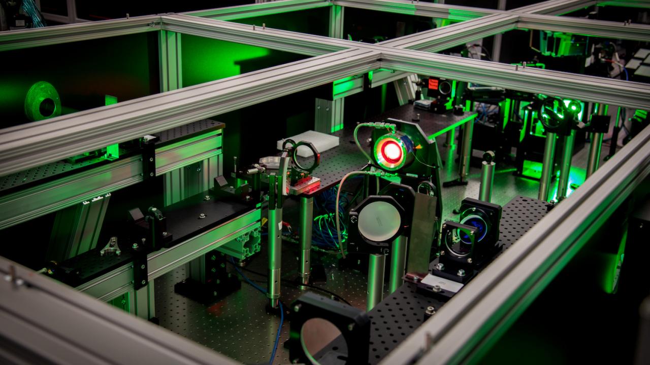 Image of a laser with green lighting at the Berkeley Lab Laser Accelerator (BELLA) Center. 