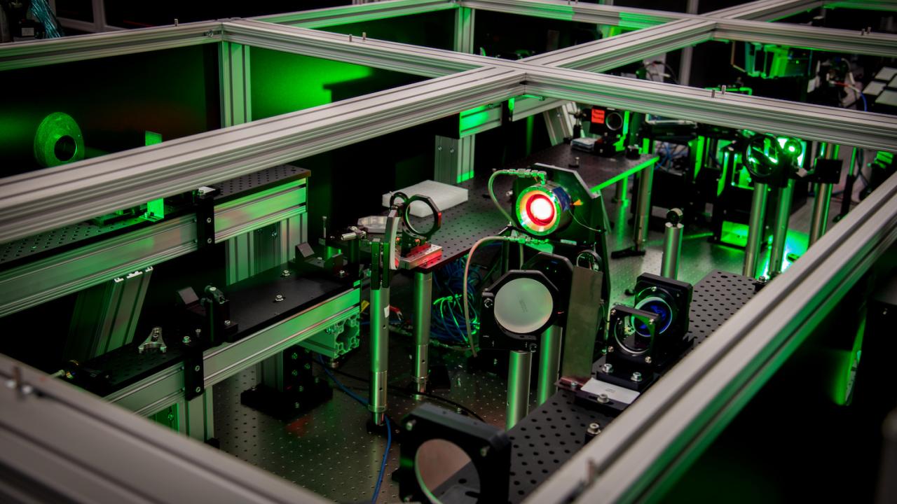 Image of a laser with green lighting at the Berkeley Lab Laser Accelerator (BELLA) Center.