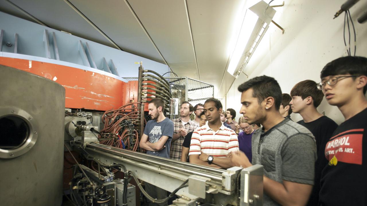 A group of students looking at equipment in the Crocker Nuclear Laboratory at UC Davis.