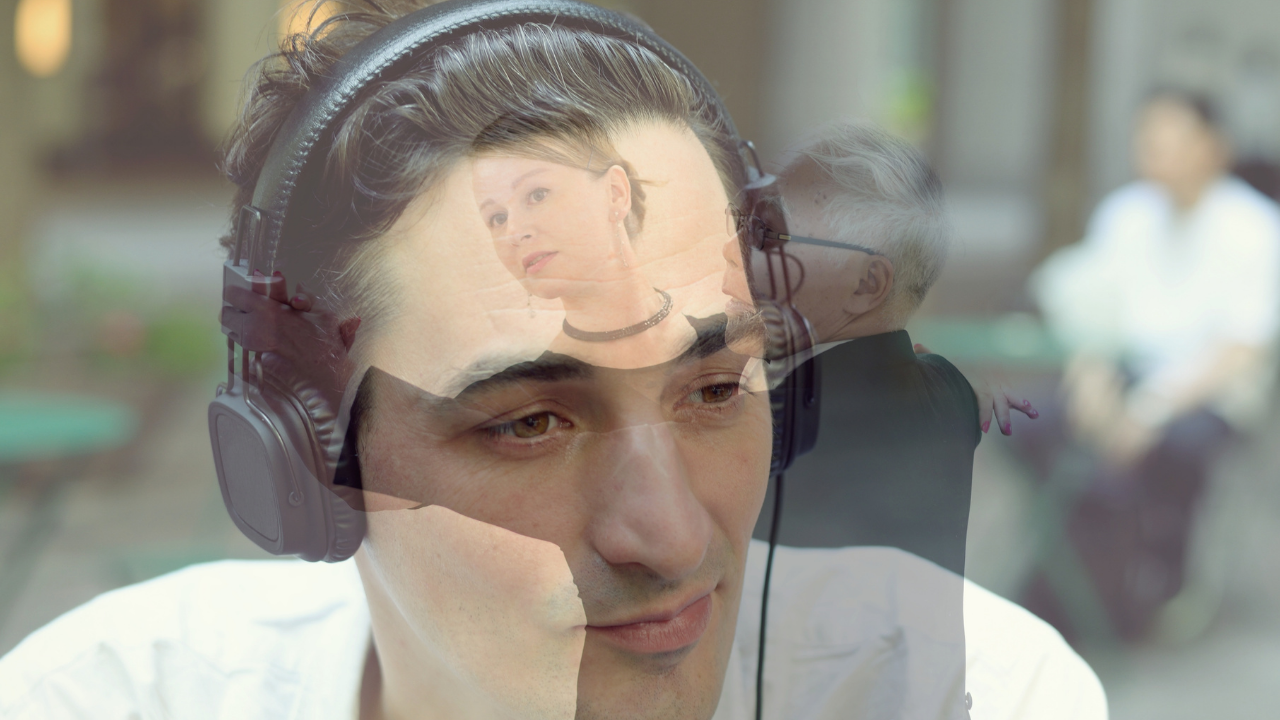Photo Illustration of man with headphones on, head resting on his hand, and a translucent image of a couple dancing playing across his face.