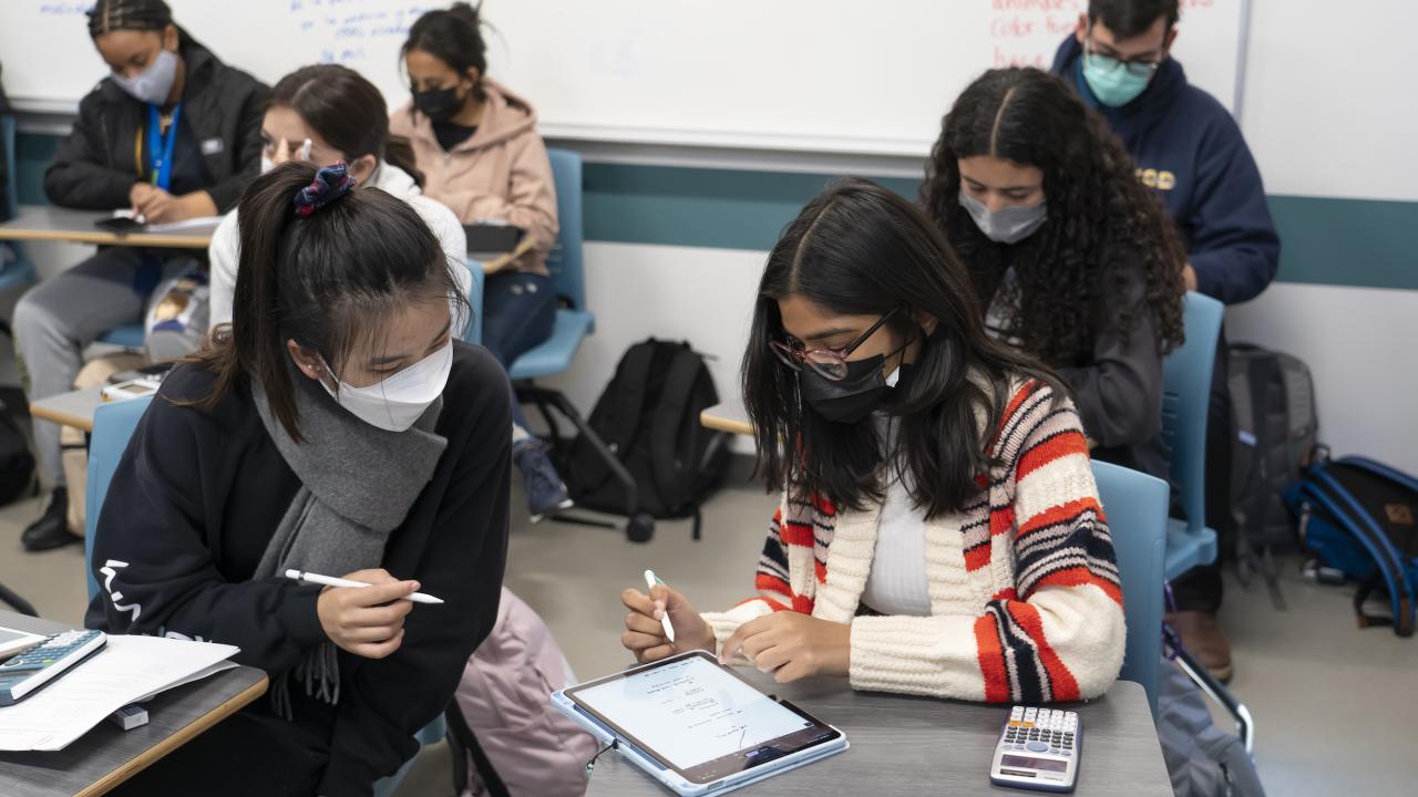 Two students look at an ipad during a chemistry class at UC Davis.