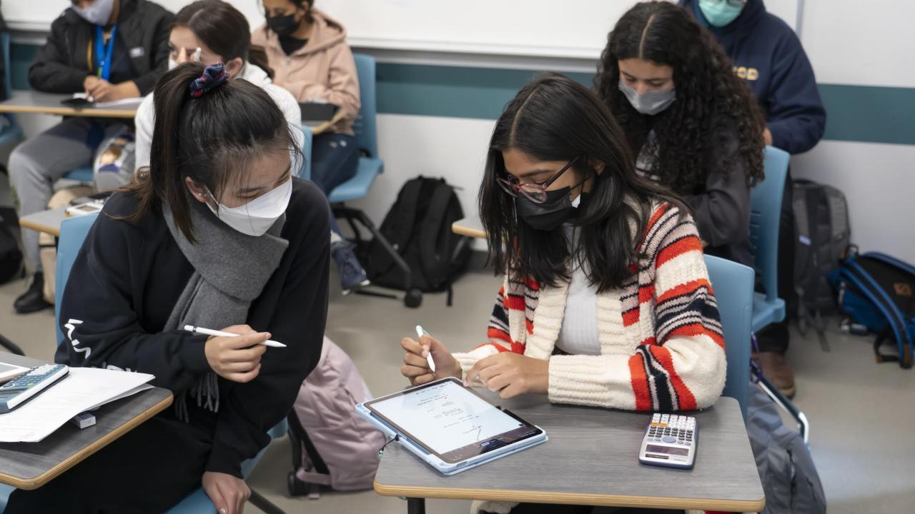 Two students look at an ipad during a chemistry class at UC Davis.