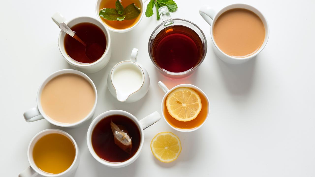 eight cups of tea looking straight down from above. white background.