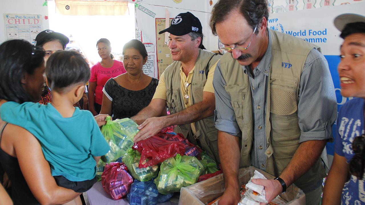 Food aid workers distributing packaged food