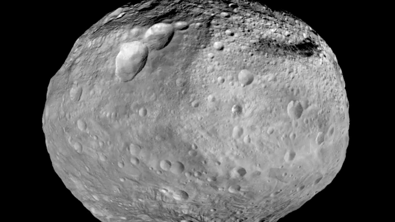 An black-and-white image of the asteroid Vesta taken by NASA's Dawn spacecraft.