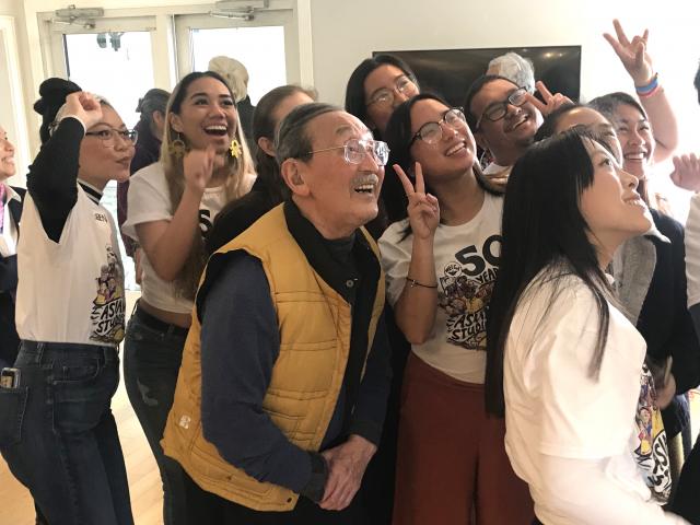 Isao Fujimoto takes a selfie with students at a recent event honoring him. 