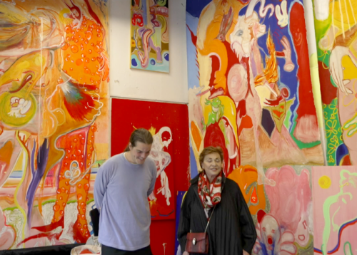 Maria Manetti Shrem visits a male graduate student's art studio filled with brightly colored paintings from floor to ceiling