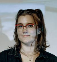 Emily Gordon stands in front of a projector.