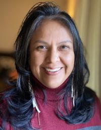 Photo of woman with dark hard and wine colored shirt