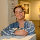 Photo of UC Davis student, smiling, inside a campus art museum.