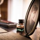 Old letters and a portrait photo on a desk