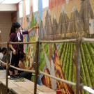 Students work on the mural during the painting of the mural in the Yolo County Juvenile Detention Facility on Wednesday May 23, 2014 in Woodside, CA. After the staff and inmates were interviewed, the mural was designed. This is the work of a single quarter of students from Chicano Studies Mural Workshop