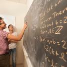 Zachary Spaulding and Yupeng Li, both math majors, work together as they talk about mathematics in the undergraduate math lounge.