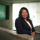 A portrait of UC Davis Dean Estella Atekwana standing in a staircase at the SS&H building.