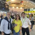 Santiago Perez (dressed in a white button-up shirt and black pants) stands with his Mom and Dad at the Buenos Aires Book Fair.