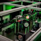Image of a laser with green lighting at the Berkeley Lab Laser Accelerator (BELLA) Center. 