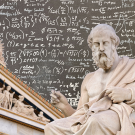 Sculpture of Greek philosopher Plato and Pantheon super-imposed on top of chalkboard with mathematical equations handwritten in chalk