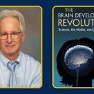 A portrait of Ross Thompson, wearing a blue shirt and tie next to a picture of his book "The Brain Development Revolution" 