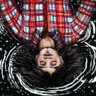 Illustration from bird's-eye view of woman's head and upper torso upside-down, eyes closed, brown hair flowing, wearing red plaid shirt, surrounded by dark space and stars