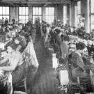 historic photo of women at sewing machines in a factory