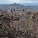 A geology class stands atop a Hawaiian volcano.