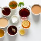 eight cups of tea looking straight down from above. white background.