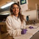 A pharmaceutical chemistry student wears gloves.